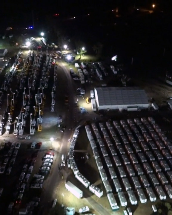 Drone shot of tents and mobile assets at night